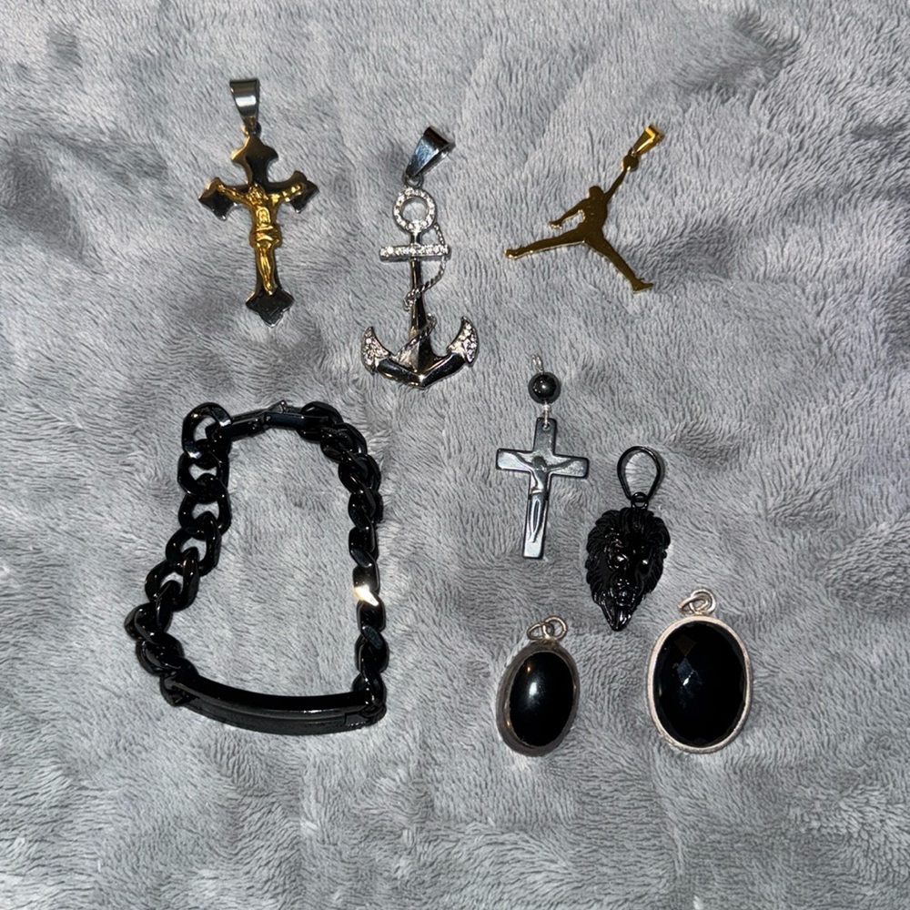 #38 Assortment of metal pendants and one black wrist chain
